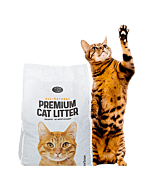 Spotted cat with paw in air next to premium cat litter bag